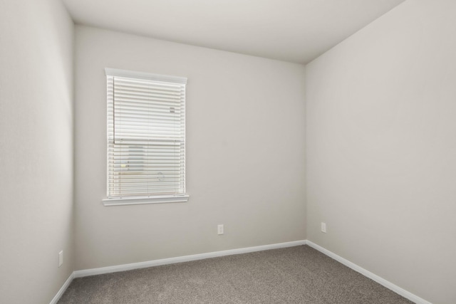 carpeted spare room with baseboards