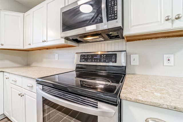 kitchen with stainless steel appliances and white cabinets