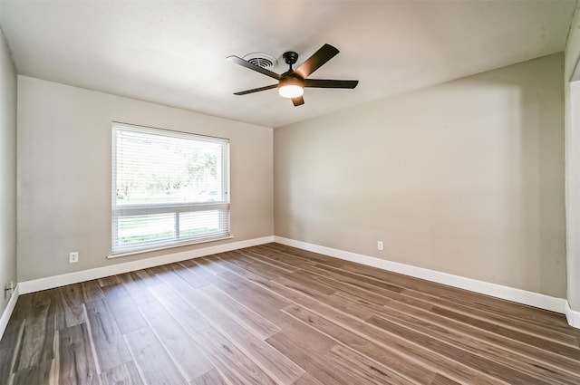 unfurnished room with a ceiling fan, baseboards, and wood finished floors