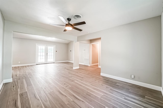 unfurnished room with light wood-type flooring, baseboards, visible vents, and french doors