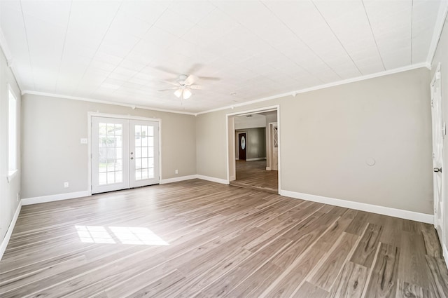 unfurnished room with light wood-style flooring, baseboards, crown molding, and french doors