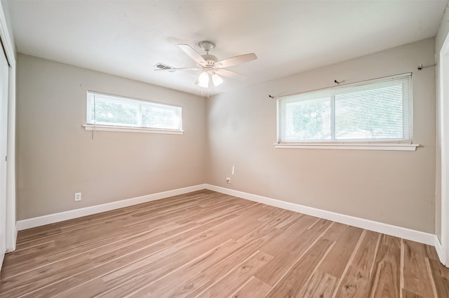 unfurnished bedroom with light wood finished floors, visible vents, baseboards, and a closet