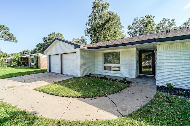 single story home with concrete driveway, brick siding, an attached garage, and a front yard