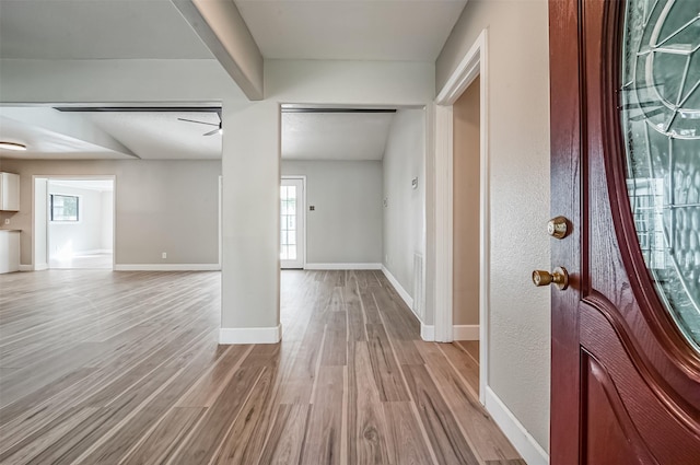 entrance foyer featuring plenty of natural light, light wood-style flooring, and baseboards