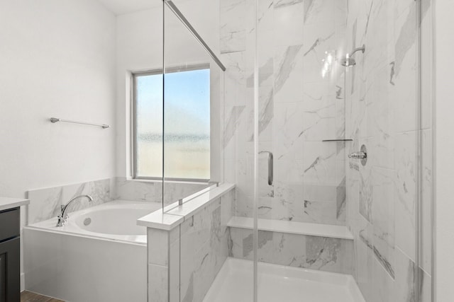 full bathroom with a garden tub, vanity, and a marble finish shower