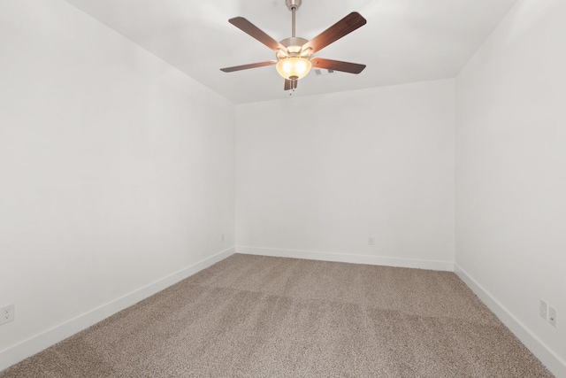 empty room featuring light carpet, baseboards, and a ceiling fan