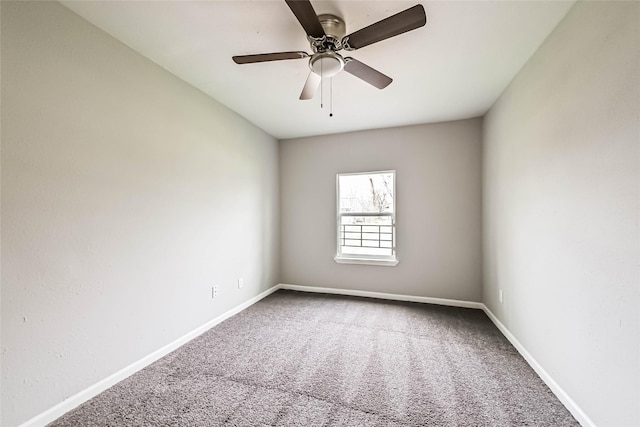 empty room with carpet, a ceiling fan, and baseboards