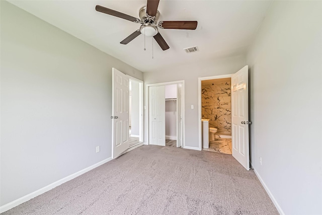 unfurnished bedroom with baseboards, visible vents, carpet flooring, and ensuite bathroom