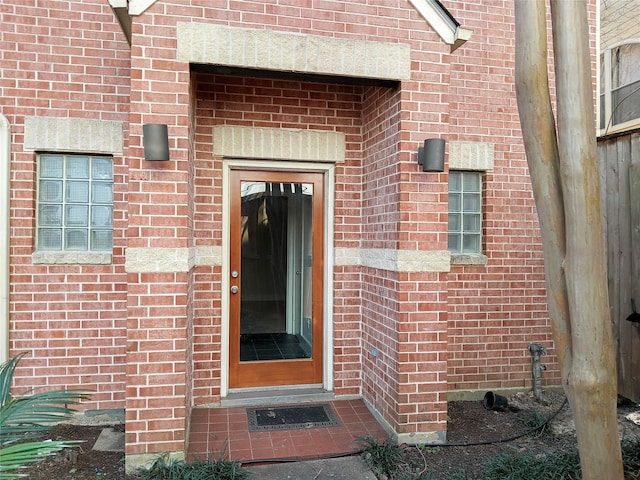 property entrance with brick siding