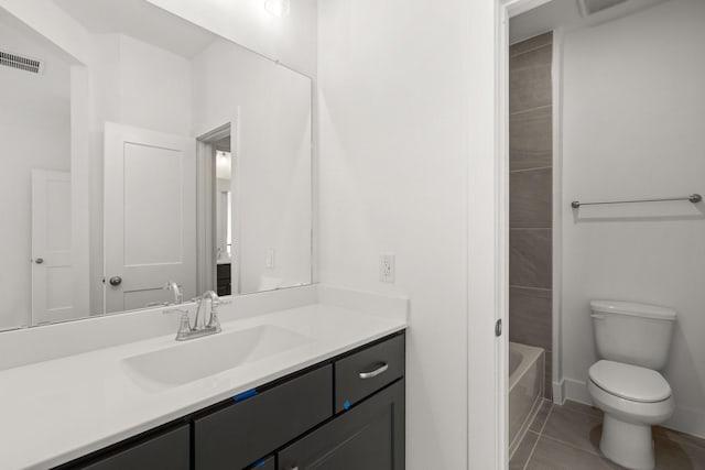 bathroom featuring visible vents, toilet, vanity, tile patterned flooring, and baseboards