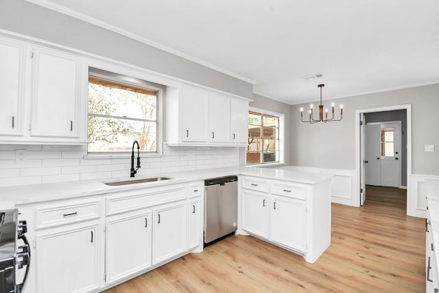 kitchen featuring stainless steel dishwasher, a sink, white cabinetry, and range with gas stovetop