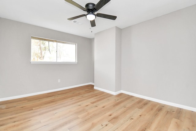 empty room with light wood finished floors, visible vents, baseboards, and ceiling fan