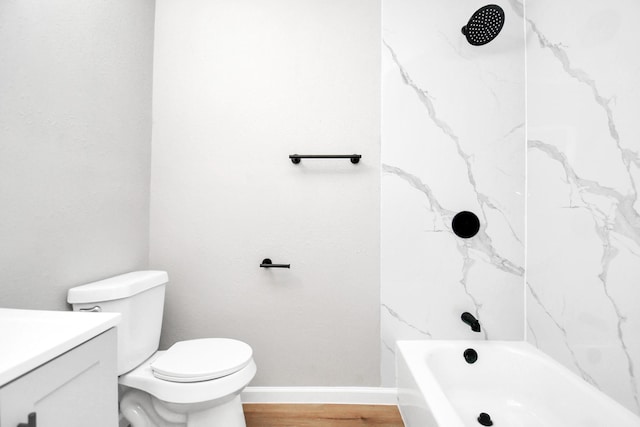 full bathroom featuring baseboards, toilet, wood finished floors, vanity, and shower / washtub combination