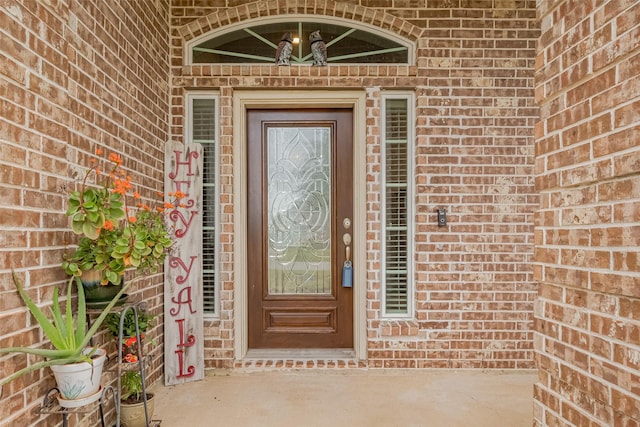 entrance to property with brick siding