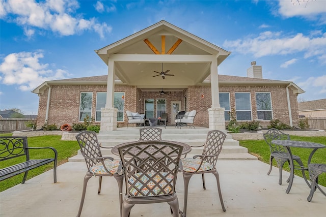 view of patio / terrace with outdoor dining space, fence, and a ceiling fan