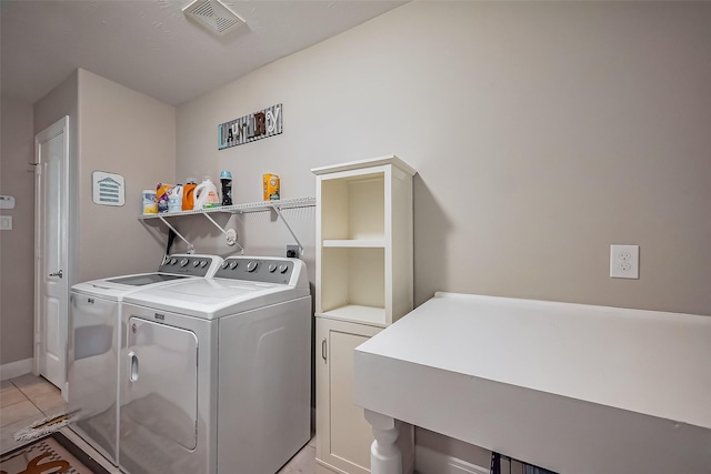 clothes washing area featuring laundry area, visible vents, separate washer and dryer, and light tile patterned flooring