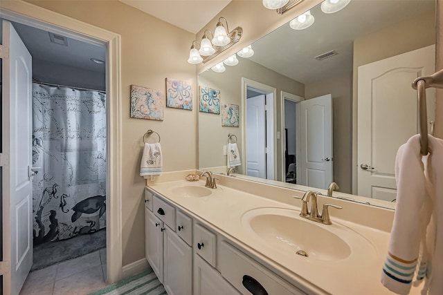 bathroom featuring double vanity, tile patterned flooring, baseboards, and a sink