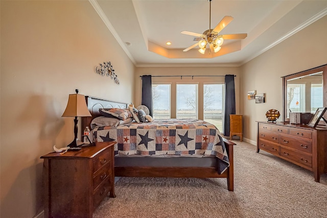 bedroom with multiple windows, a raised ceiling, crown molding, and light colored carpet