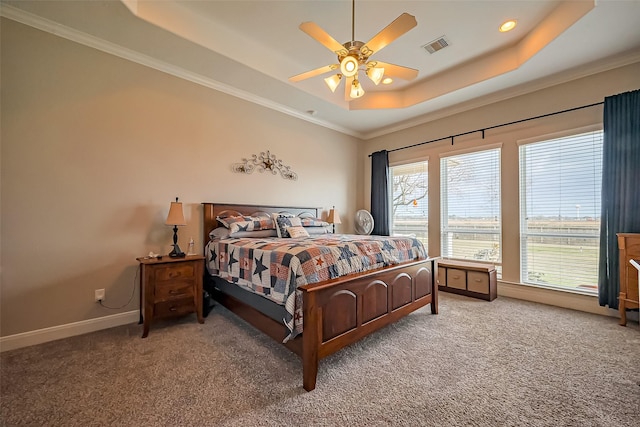 bedroom featuring carpet floors, visible vents, baseboards, and a raised ceiling