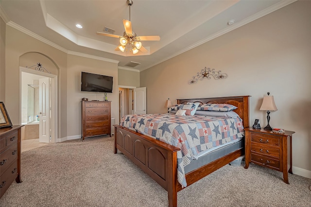 bedroom featuring light carpet, baseboards, visible vents, a raised ceiling, and ornamental molding