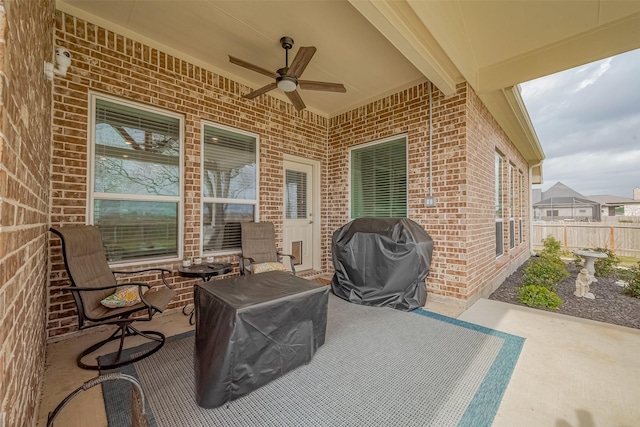 view of patio / terrace featuring a grill, a ceiling fan, and fence