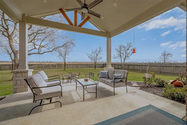 view of patio featuring outdoor lounge area, a fenced backyard, and a ceiling fan