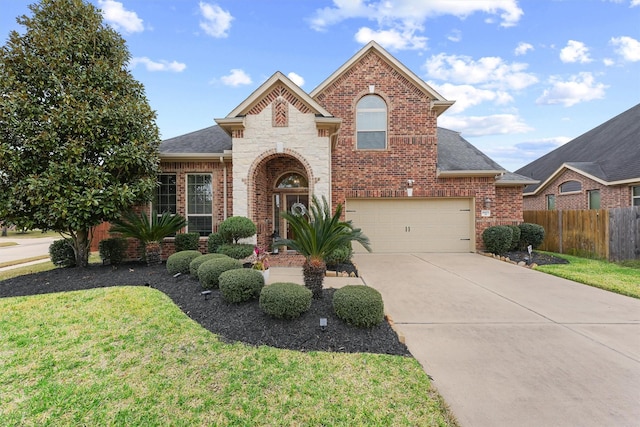 traditional-style house with brick siding, concrete driveway, and fence