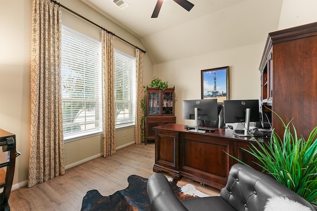 office space with visible vents, baseboards, ceiling fan, vaulted ceiling, and light wood-style flooring