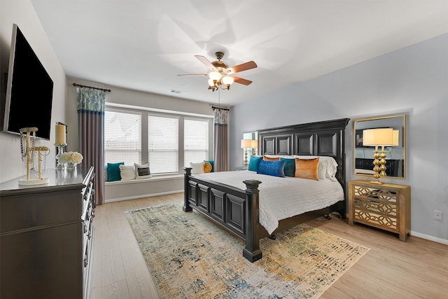 bedroom with visible vents, a ceiling fan, light wood-type flooring, and baseboards