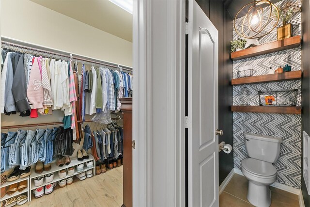 8603 Rexford Cove Ct, Richmond, TX 77407 - interior space featuring wood finished floors, a spacious closet, and toilet