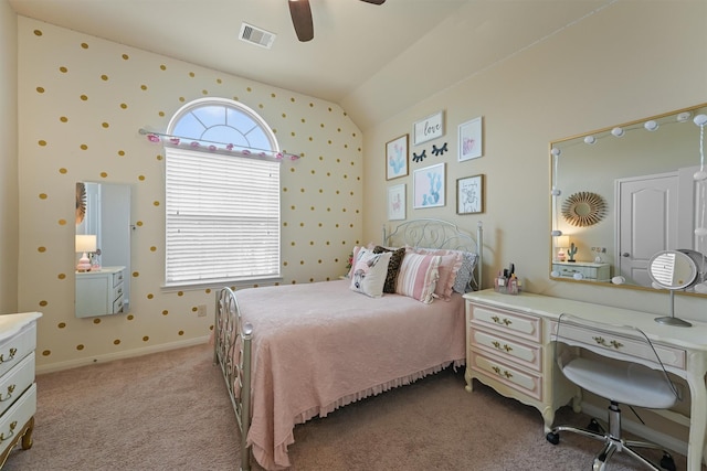 bedroom featuring baseboards, visible vents, carpet floors, wallpapered walls, and vaulted ceiling