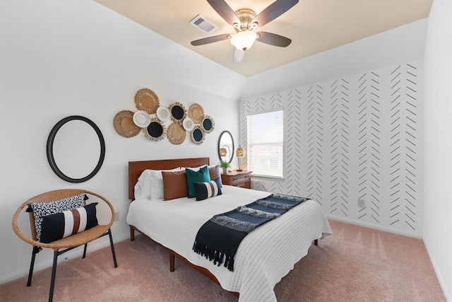 carpeted bedroom featuring a ceiling fan, vaulted ceiling, baseboards, and visible vents