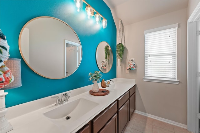 full bathroom featuring tile patterned floors, double vanity, baseboards, and a sink