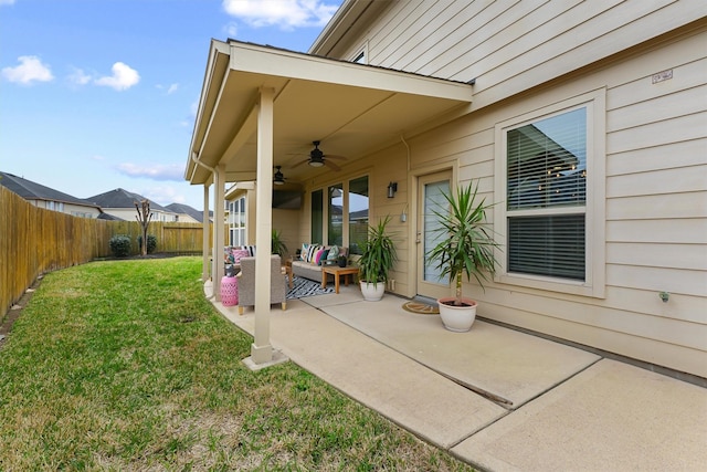 view of patio / terrace with an outdoor living space, a fenced backyard, and ceiling fan