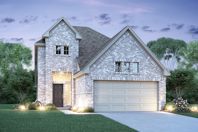 french provincial home with a garage, a shingled roof, concrete driveway, and brick siding