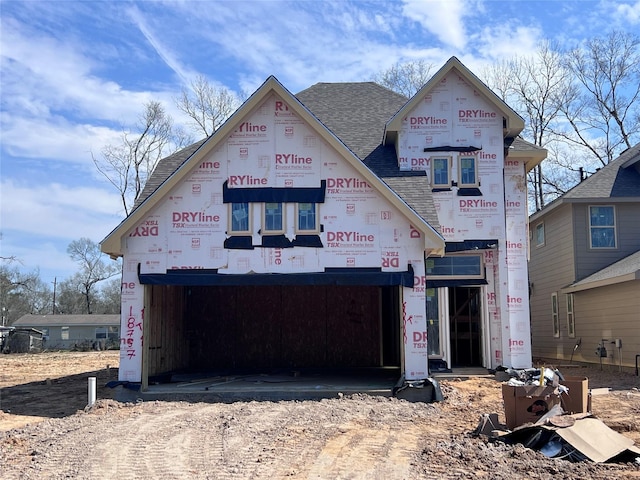property in mid-construction featuring a shingled roof and dirt driveway