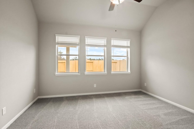 unfurnished room with a wealth of natural light, lofted ceiling, a ceiling fan, and carpet floors