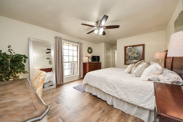 bedroom featuring a ceiling fan, wood finished floors, and a closet