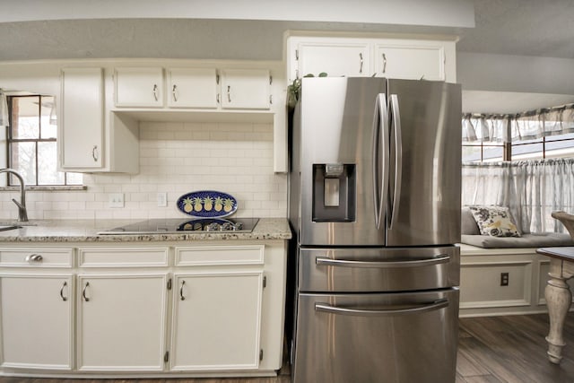 kitchen featuring backsplash, dark wood finished floors, stainless steel fridge with ice dispenser, and white cabinetry