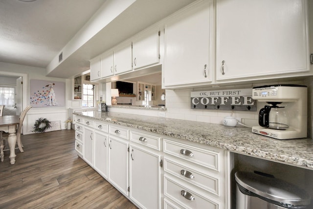 kitchen with visible vents, backsplash, white cabinetry, light stone countertops, and dark wood-style flooring