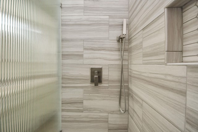 full bathroom with tiled shower