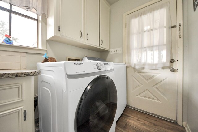 washroom featuring cabinet space, independent washer and dryer, and dark wood-style flooring