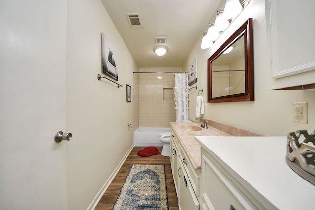 bathroom with visible vents, toilet, wood finished floors, and vanity