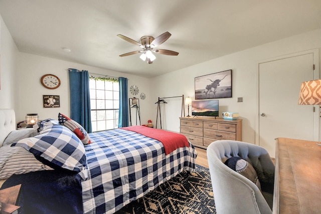 bedroom with a ceiling fan and wood finished floors