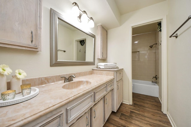 full bathroom featuring baseboards,  shower combination, wood finished floors, and vanity