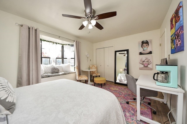 bedroom featuring a closet, wood finished floors, and a ceiling fan