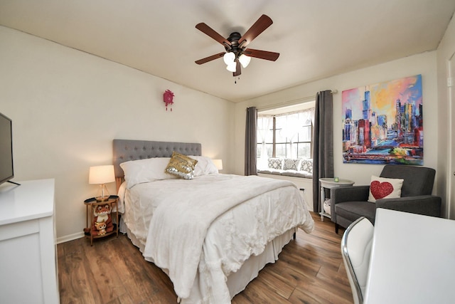 bedroom with baseboards, a ceiling fan, and wood finished floors