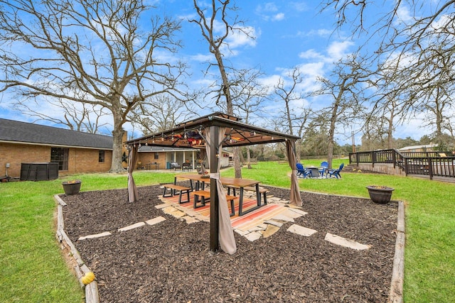 view of property's community with a patio, fence, an outdoor fire pit, a gazebo, and a lawn