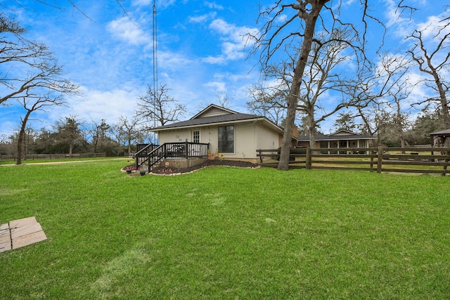 view of yard with fence and a wooden deck