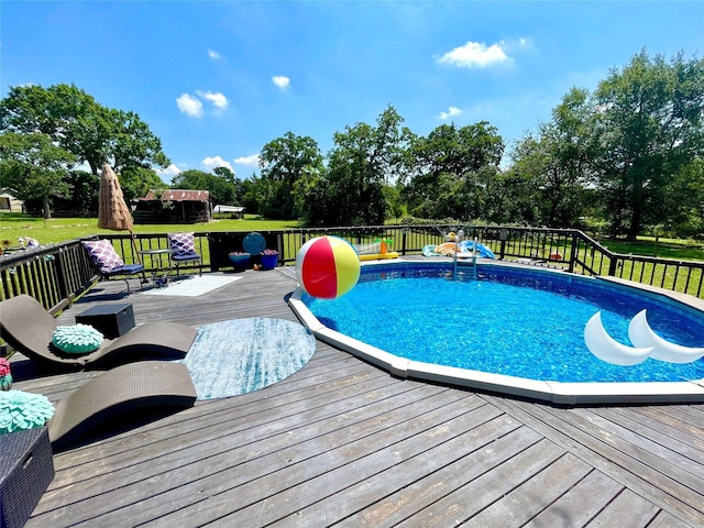 pool featuring a lawn and a deck